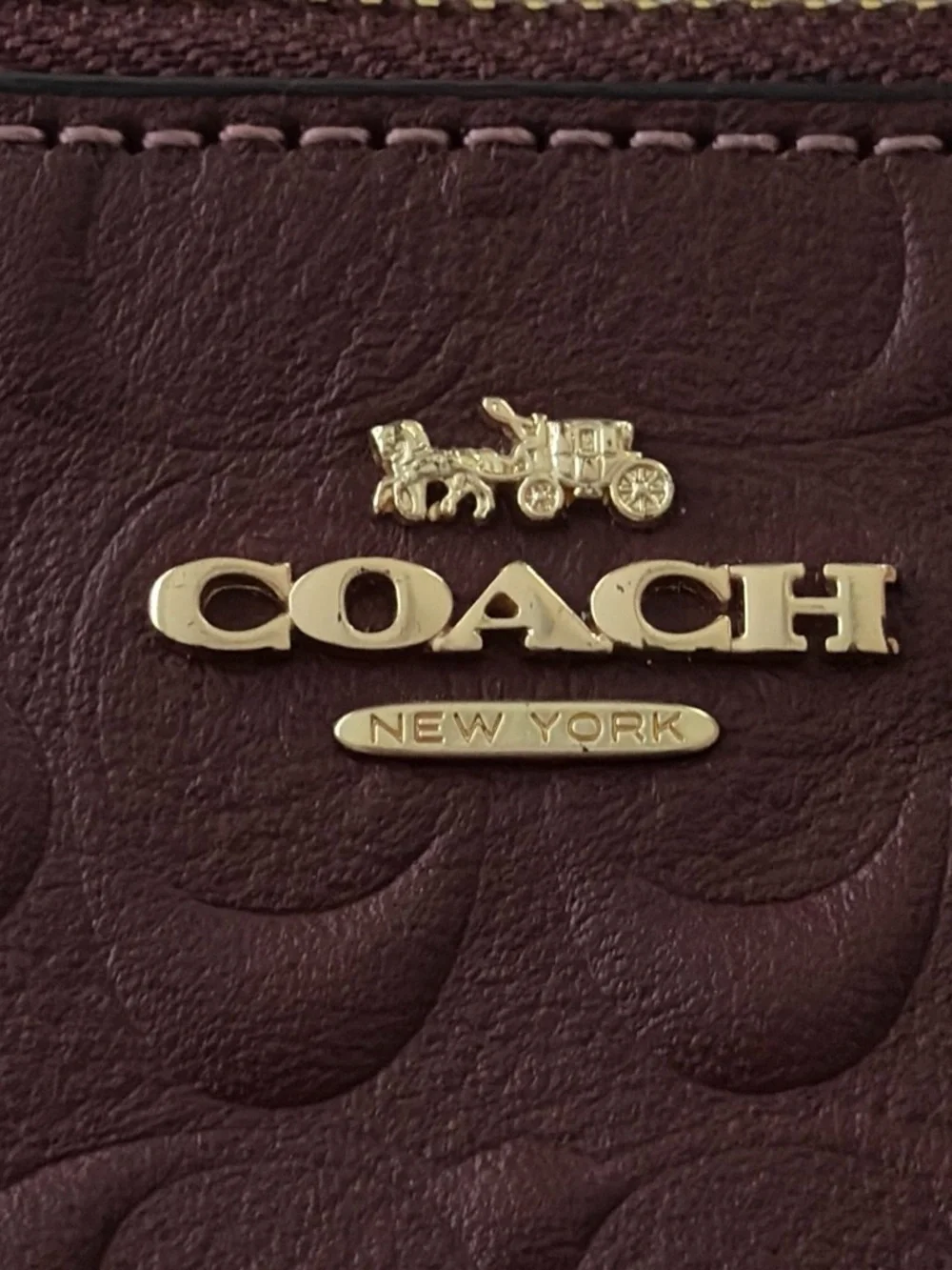 COACH Embossed Signature Wristlet in burgundy with Gold Logo, used once